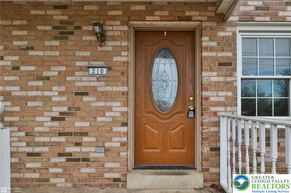 a view of entryway with wooden floor and stairs
