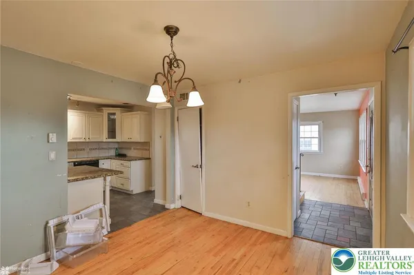 a view of a room with wooden floor and window