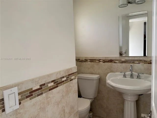 a bathroom with a toilet and a picture of a window