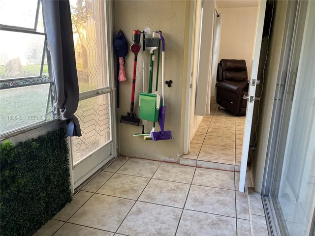 a view of a glass door with a yard from a window