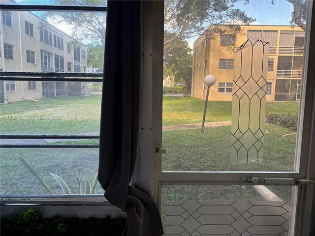 a view of a cars park in front of a building