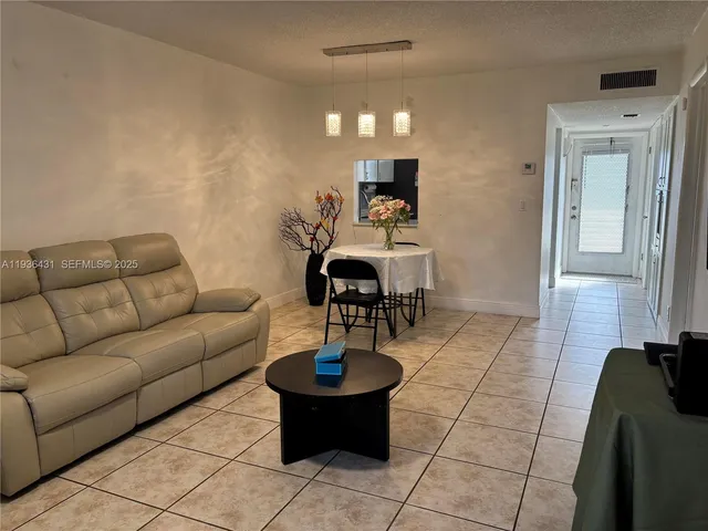 a view of a cars park in front of a building