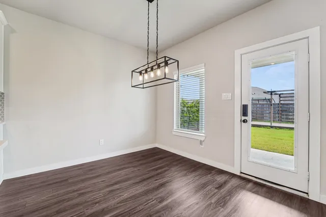 a view of wooden floor and windows in a room