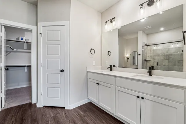 a bathroom with a double vanity sink and mirror