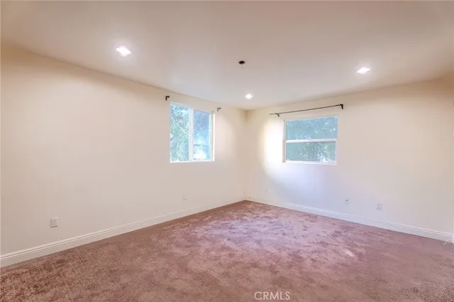 an empty room with a empty space and windows