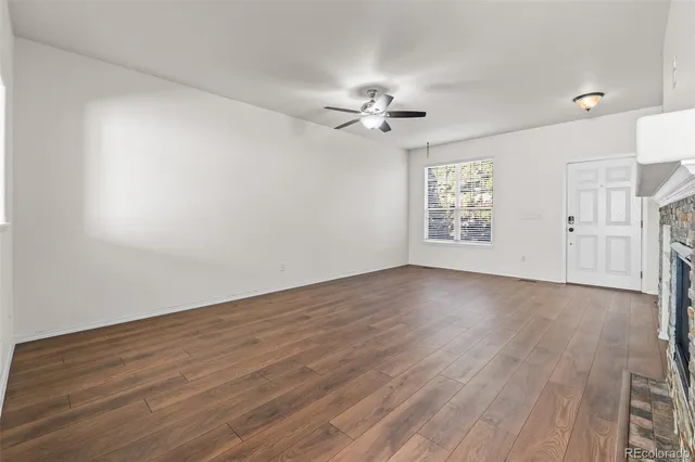 wooden floor in an empty room with a window