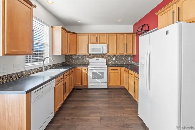 a kitchen with kitchen island a sink a counter top space stainless steel appliances and a window