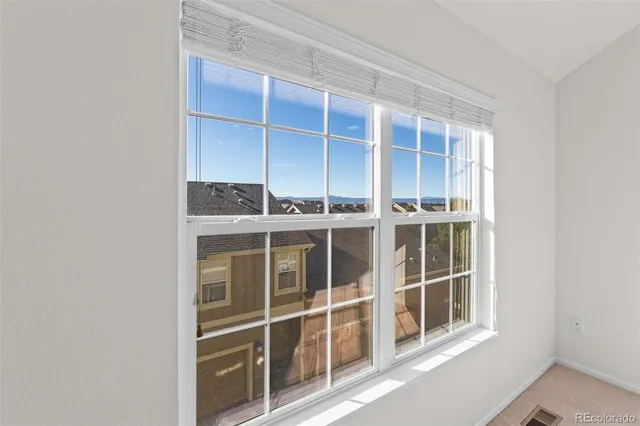 an empty room with closet and fan