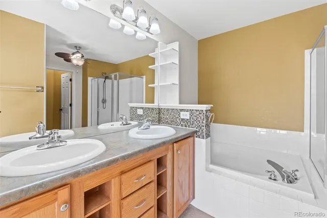 a bathroom with a granite countertop sink a mirror and a bathtub