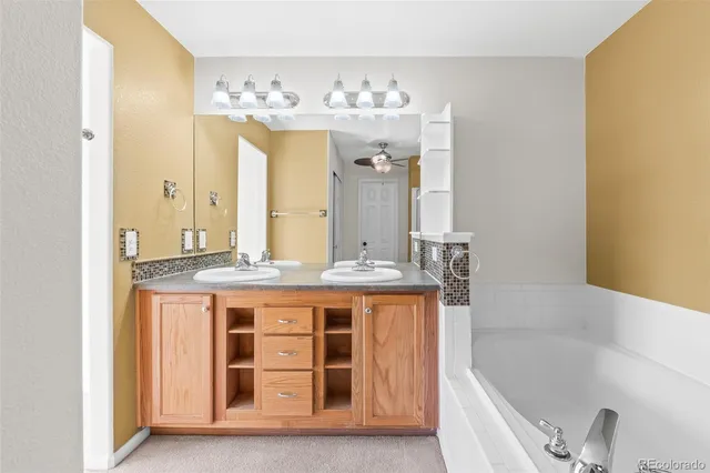 a bathroom with a tub shower and sink