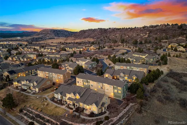 an aerial view of a house with a mountain