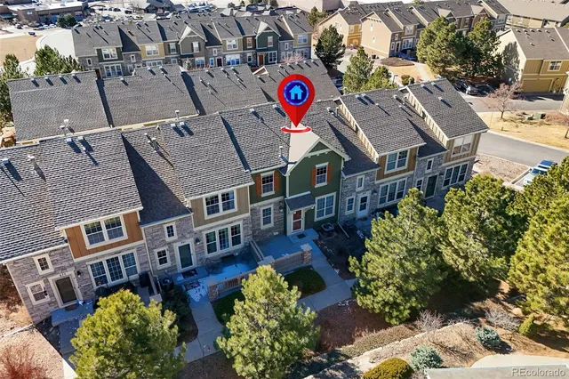 an aerial view of residential houses and car parked