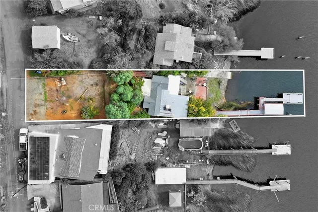 an aerial view of a house with a yard swimming pool and outdoor seating