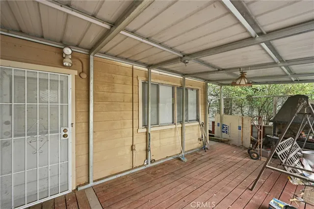 a view of a room with wooden floor and furniture