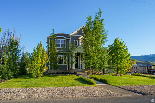 681 Island Road Morgan, UT 84050 - Photo 37 of 49 Two-story residence featuring gray siding, white trim, and a prominent arched window dormer