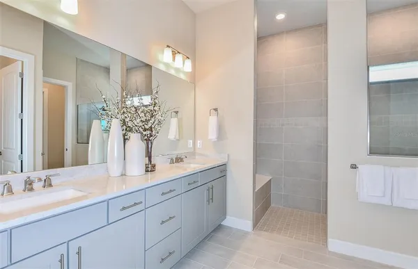 a bathroom with a double vanity sink and a mirror