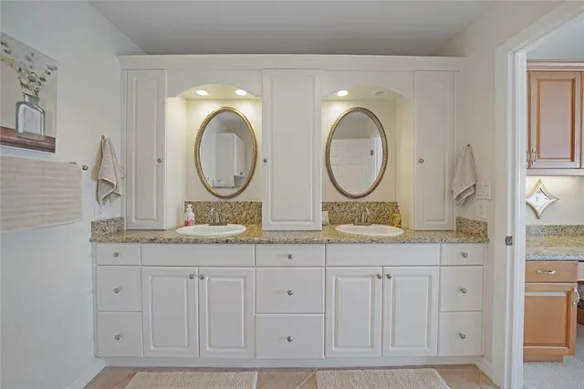 a bathroom with double sink and a mirror