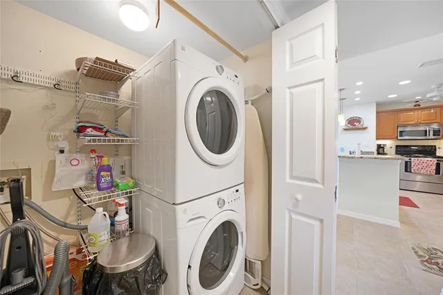 a utility room with dryer washer and a view of living room
