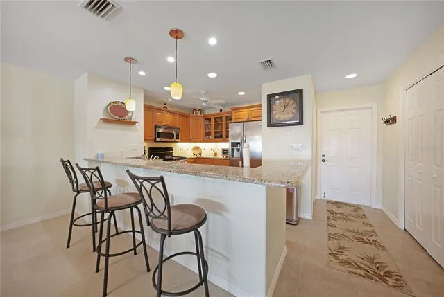 a kitchen view with stainless steel appliances a refrigerator and microwave