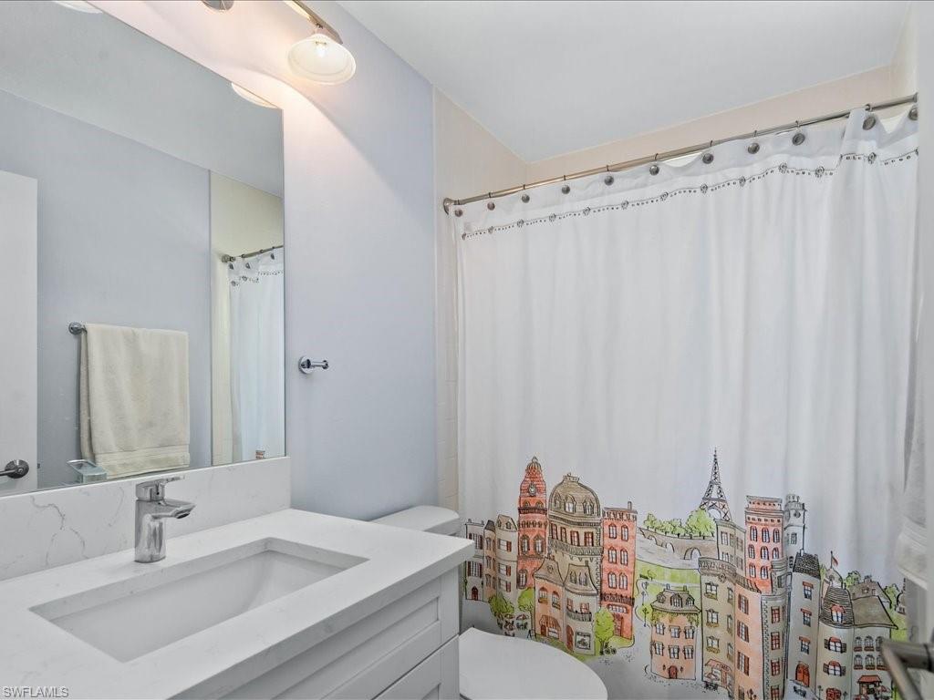 520 Soll Street Naples, FL 34109 - Photo 12 of 31 a bathroom with a sink toilet and shower
