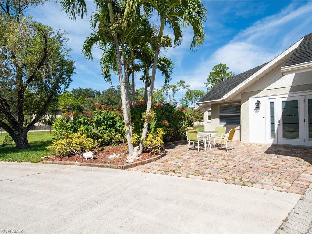 520 Soll Street Naples, FL 34109 - Photo 18 of 31 a row of palm trees in front of a house