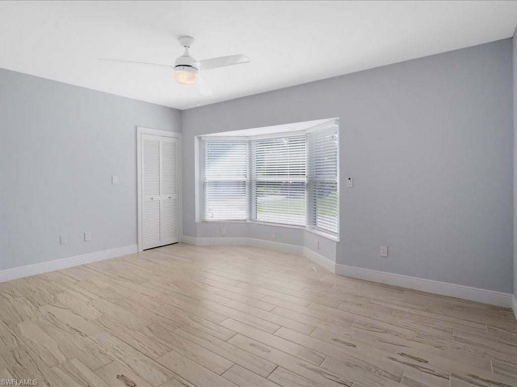 520 Soll Street Naples, FL 34109 - Photo 21 of 31 wooden floor in an empty room with a window