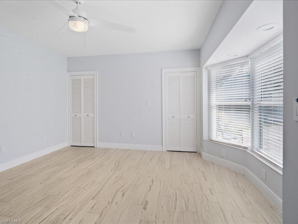 520 Soll Street Naples, FL 34109 - Photo 22 of 31 a view of an empty room with wooden floor and a window