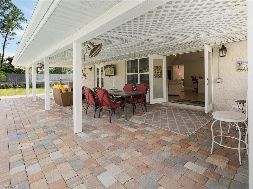 520 Soll Street Naples, FL 34109 - Photo 27 of 31 a view of a patio with table and chairs