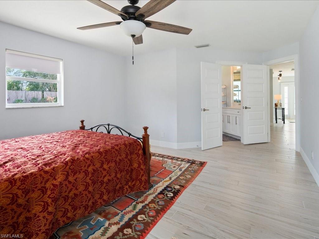 520 Soll Street Naples, FL 34109 - Photo 29 of 31 a bed sitting in a spacious bedroom next to a window