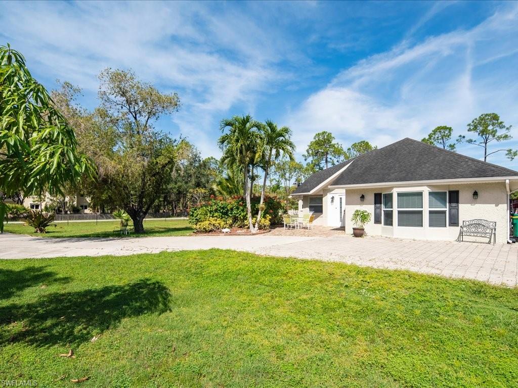 520 Soll Street Naples, FL 34109 - Photo 30 of 31 a front view of a house with a garden