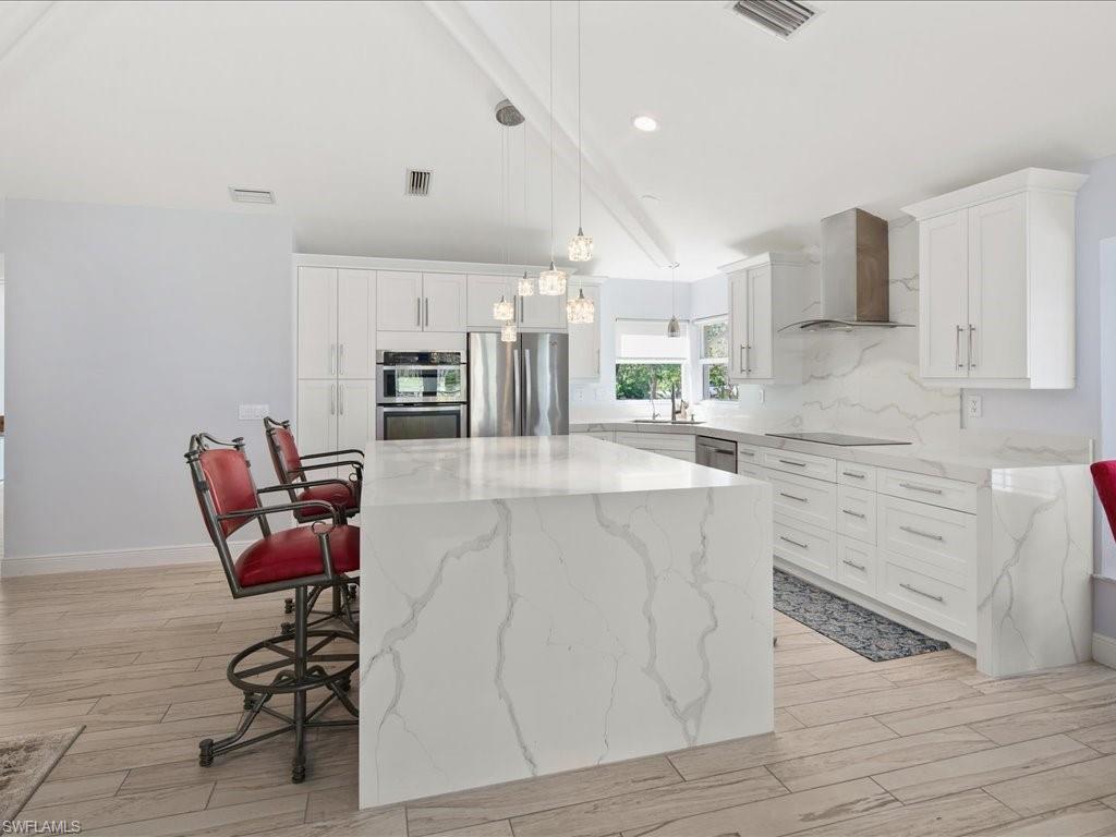 520 Soll Street Naples, FL 34109 - Photo 4 of 31 a large white kitchen with cabinets