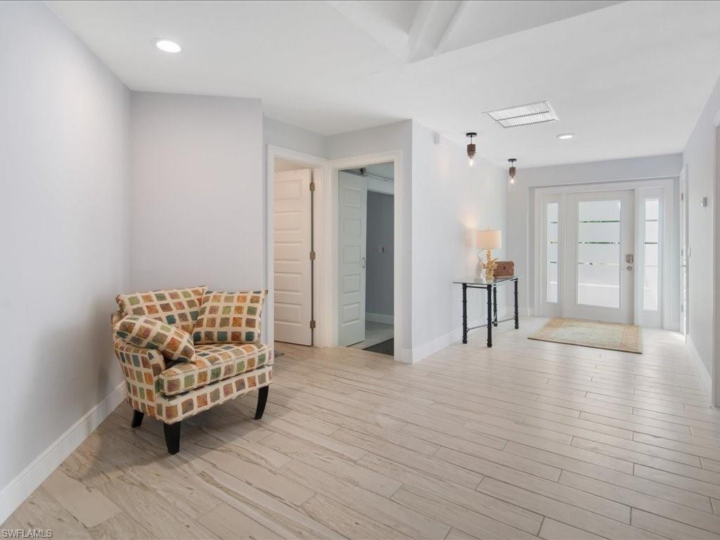 520 Soll Street Naples, FL 34109 - Photo 5 of 31 a living room with furniture and a wooden floor