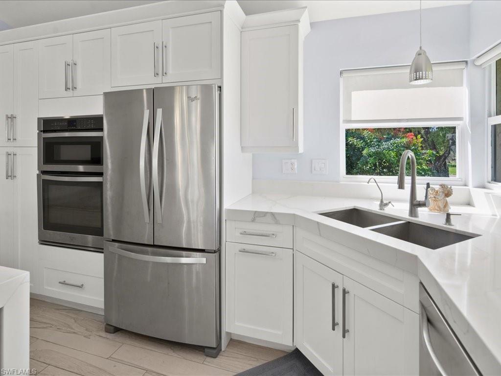 520 Soll Street Naples, FL 34109 - Photo 7 of 31 a kitchen with appliances a sink and a window