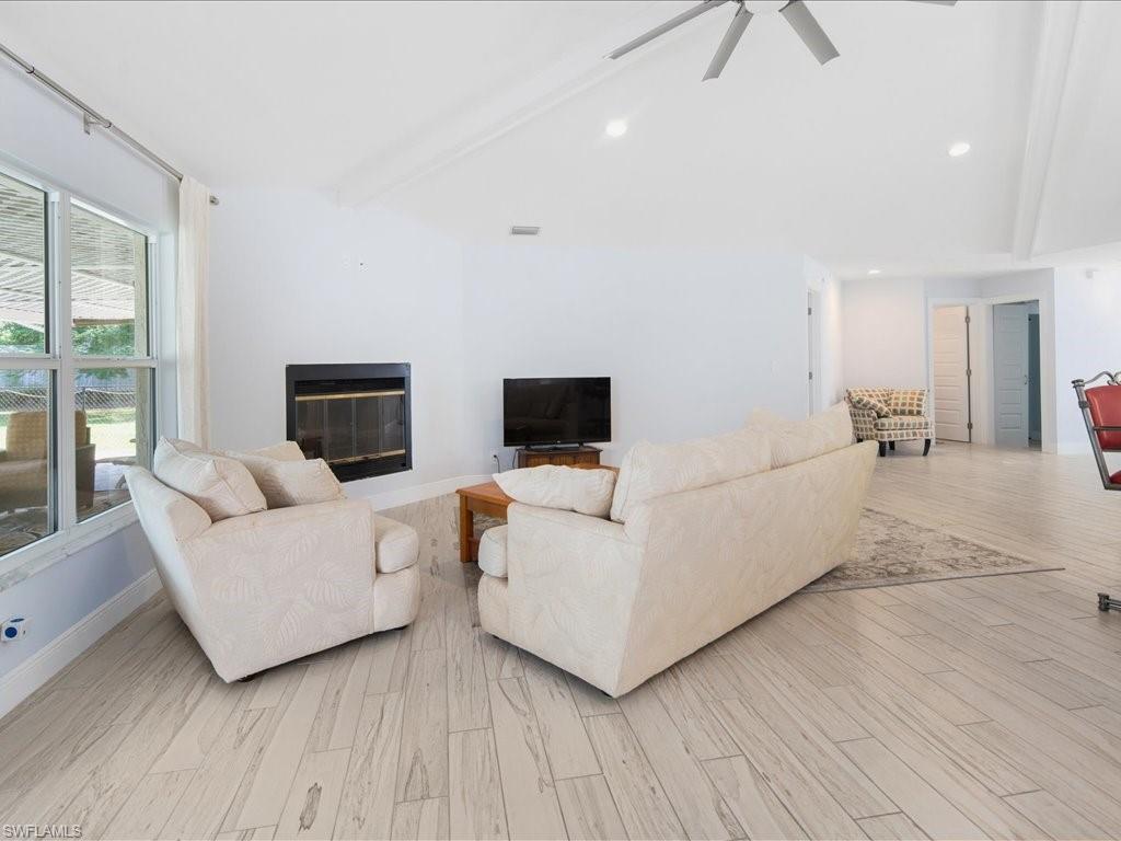520 Soll Street Naples, FL 34109 - Photo 8 of 31 a living room with furniture and a flat screen tv