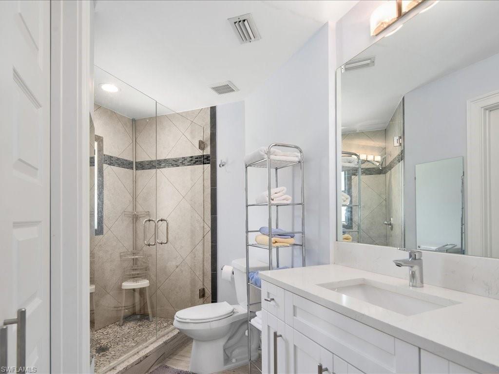 520 Soll Street Naples, FL 34109 - Photo 10 of 31 a bathroom with a sink toilet a mirror and shower