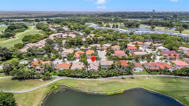 an aerial view of residential houses with outdoor space and swimming pool