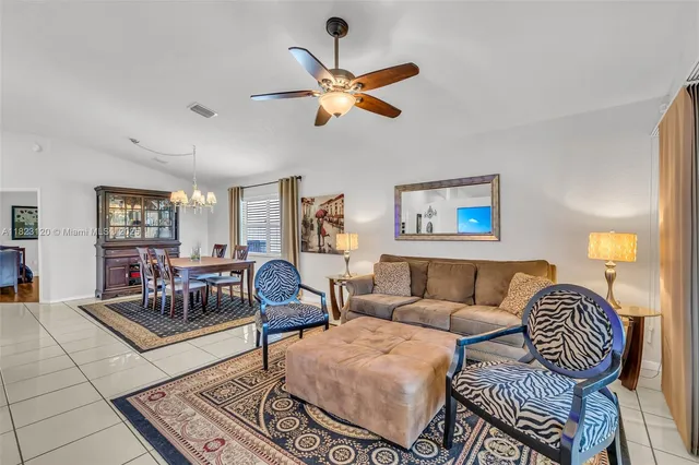 a living room with furniture and a ceiling fan