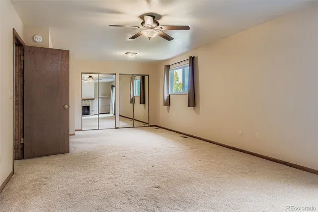 an empty room with furniture and a fireplace