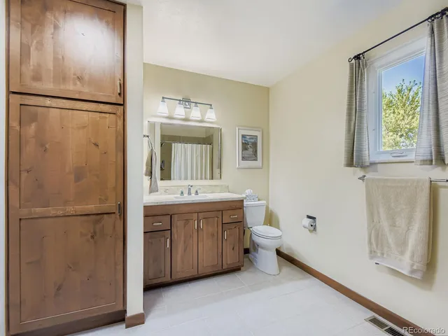 a bathroom with a double vanity sink a mirror and a bathtub