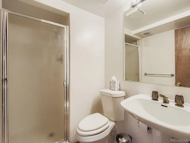 a balcony with wooden floor and outdoor seating