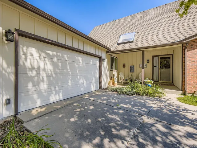 a kitchen with stainless steel appliances granite countertop a refrigerator oven a stove top oven a dining table and chairs with wooden floor