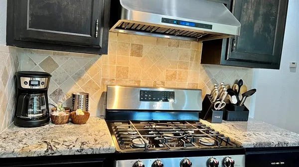 a kitchen with a stove and a refrigerator