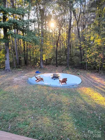 a view of a house with backyard sitting area and garden