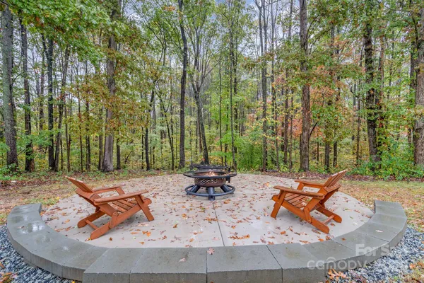 a view of house with backyard and trees