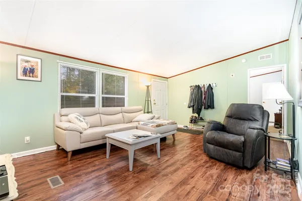 a dining room with furniture a window and wooden floor