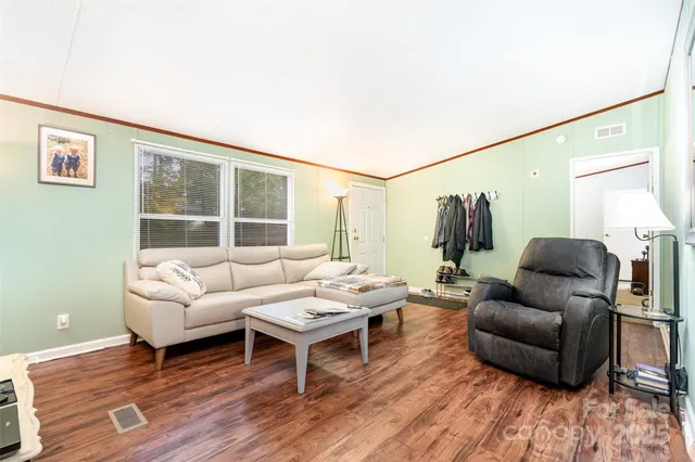 a dining room with furniture a window and wooden floor