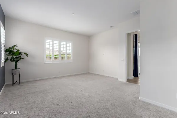 an empty room with windows and flower pot