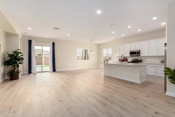 a large kitchen with stainless steel appliances granite countertop a large window a oven and a sink