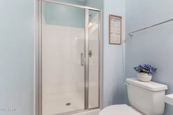 a white toilet sitting next to a bathroom sink