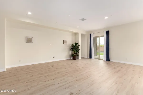a view of an empty room with potted plant and windows